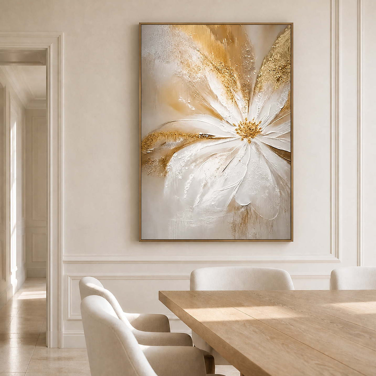 Wood-framed One Bloom of Joy on a paneled wall beside a light wood dining table and cream chairs.
