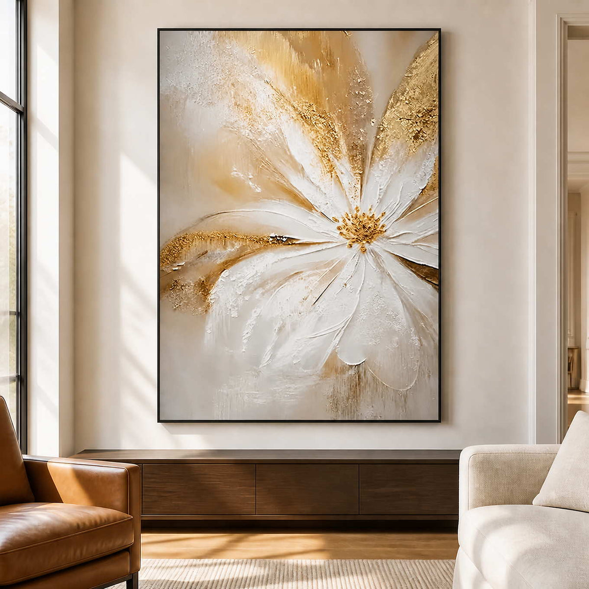 Black-framed One Bloom of Joy beside a tall window between a leather chair and a cream lounge chair.