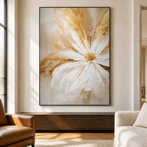 Black-framed One Bloom of Joy beside a tall window between a leather chair and a cream lounge chair.