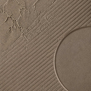 Close-up of diagonal grooves meeting a rounded plaster relief.