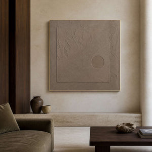 Textured wabi-sabi wall art displayed in a warm travertine living room.