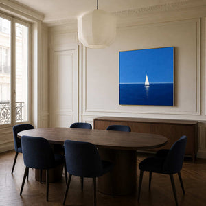 Blue sailboat wall art displayed in an elegant modern dining room.