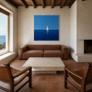 Blue sailboat wall art displayed in a warm coastal living room.