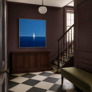 Blue sailboat wall art displayed in a classic residential stair hall.