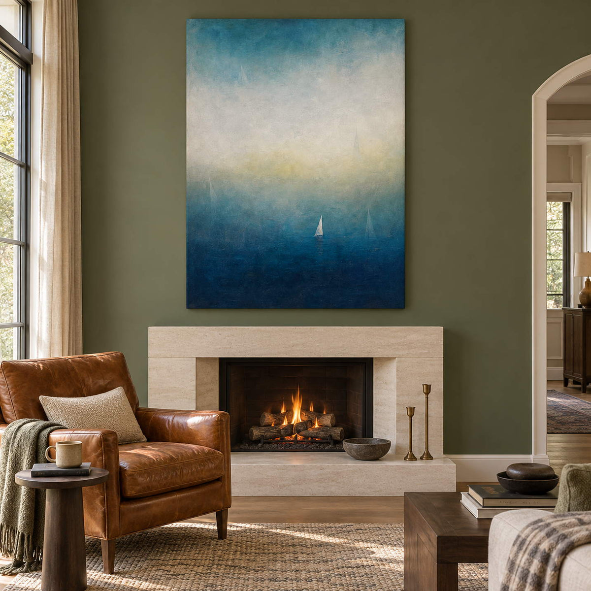 Atmospheric coastal painting with a white sail drifting across deep teal water, displayed beside or above a fireplace without an outer frame.