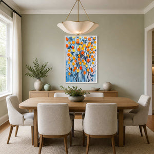 Bright floral wall art displayed in a pale green dining room.