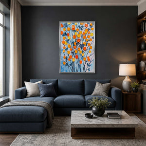 Colorful botanical artwork displayed above a navy modern living room sofa.
