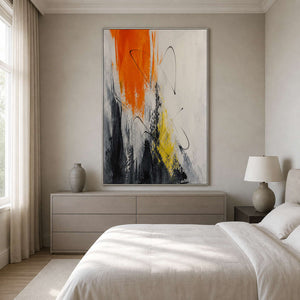 Orange, black, and white wall art displayed in a soft neutral bedroom.