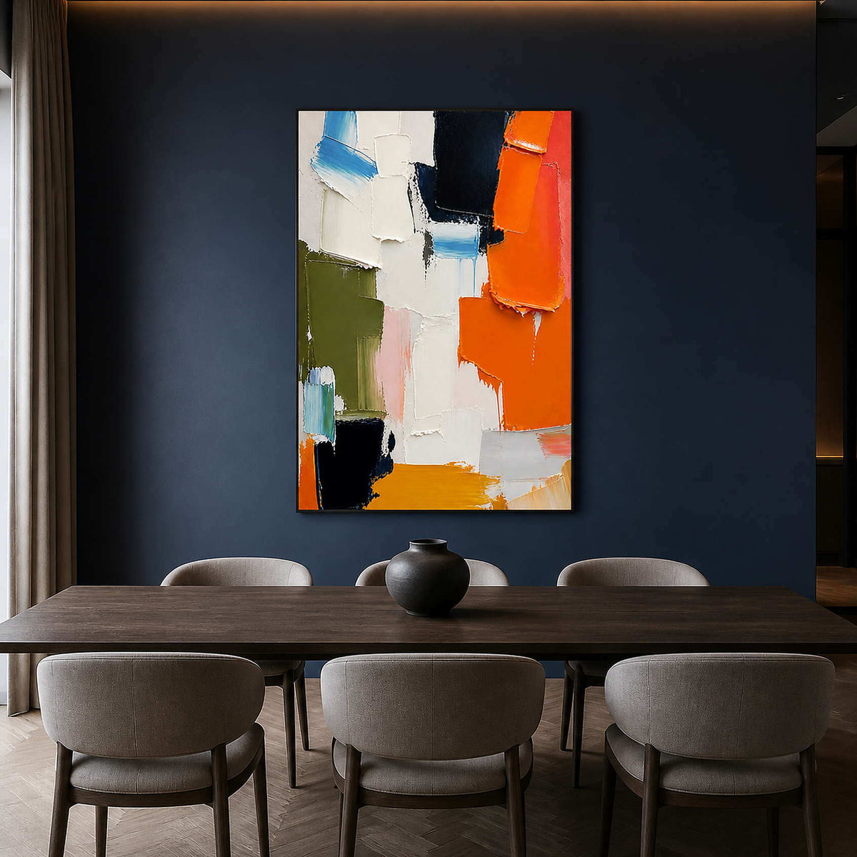 Orange and navy abstract artwork above a dark wood dining table.