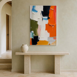 Colorful vertical artwork displayed above a limestone entryway console.