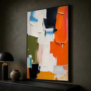 Bright orange and navy artwork creating contrast in a dark office.