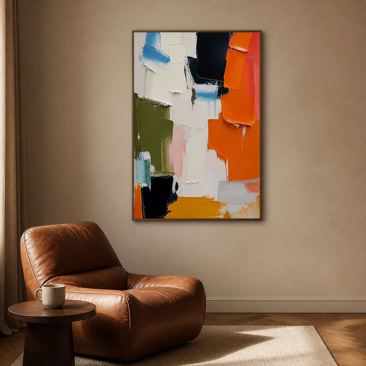Expressive orange abstract wall art beside a leather reading chair.