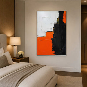 Vertical orange and black abstract canvas beside a neutral bedroom.