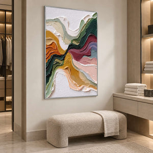 Green and burgundy abstract artwork above a pale bench in a wood-accented dressing area.