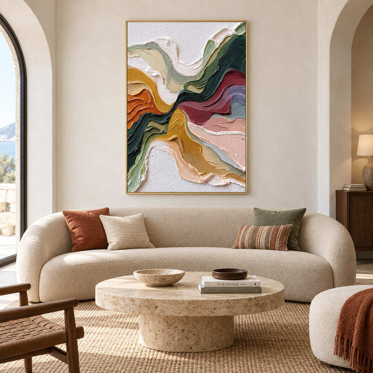 Flowing multicolor artwork above a curved cream sofa with rust and green cushions.