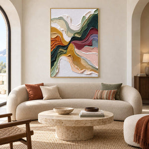 Flowing multicolor artwork above a curved cream sofa with rust and green cushions.