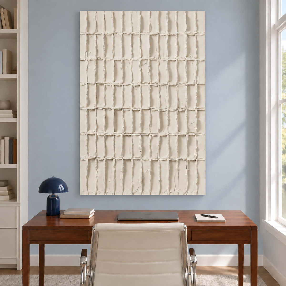 Ivory rectangle painting above a wooden desk and white chair.