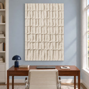 Ivory rectangle painting above a wooden desk and white chair.
