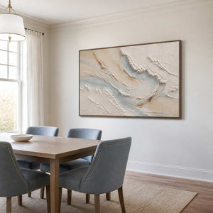 Soft coastal abstract wall art in a bright dining room with a wood frame.