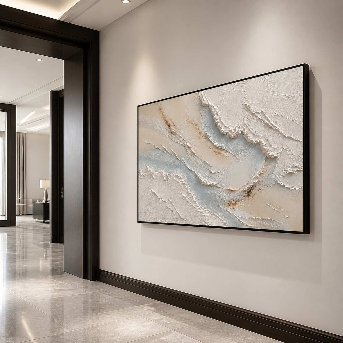 Horizontal textured coastal wall art in a luxury entryway with a black frame.