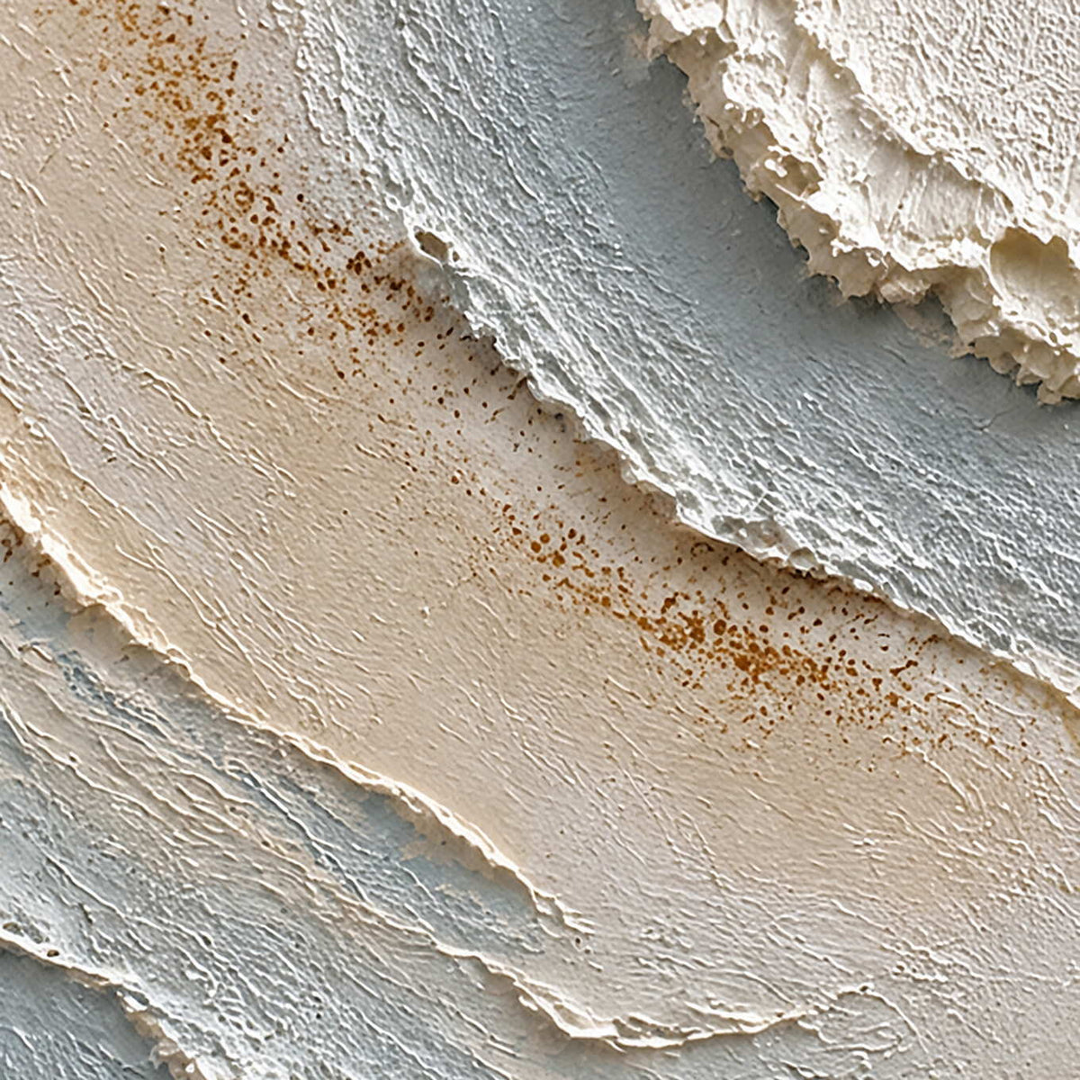 Close-up of raised ivory, misty blue, and warm-brown hand-painted texture.