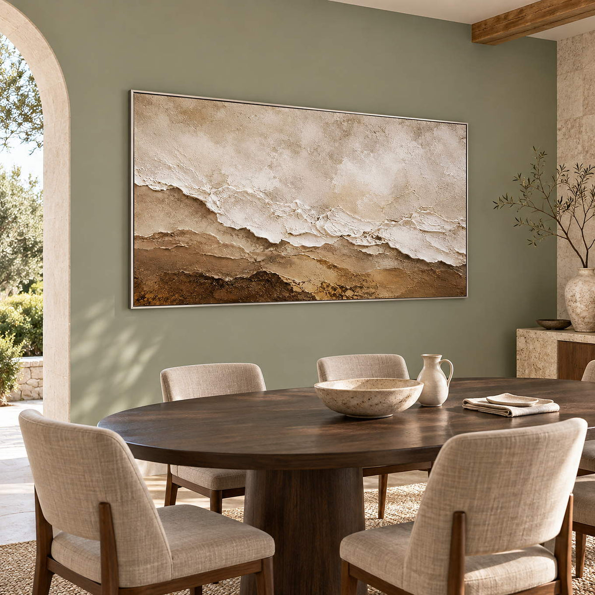 Hand-painted ivory, beige, and brown textured abstract canvas, displayed in a dining room in a silver frame.