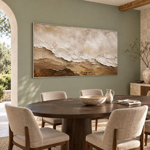 Hand-painted ivory, beige, and brown textured abstract canvas, displayed in a dining room in a silver frame.