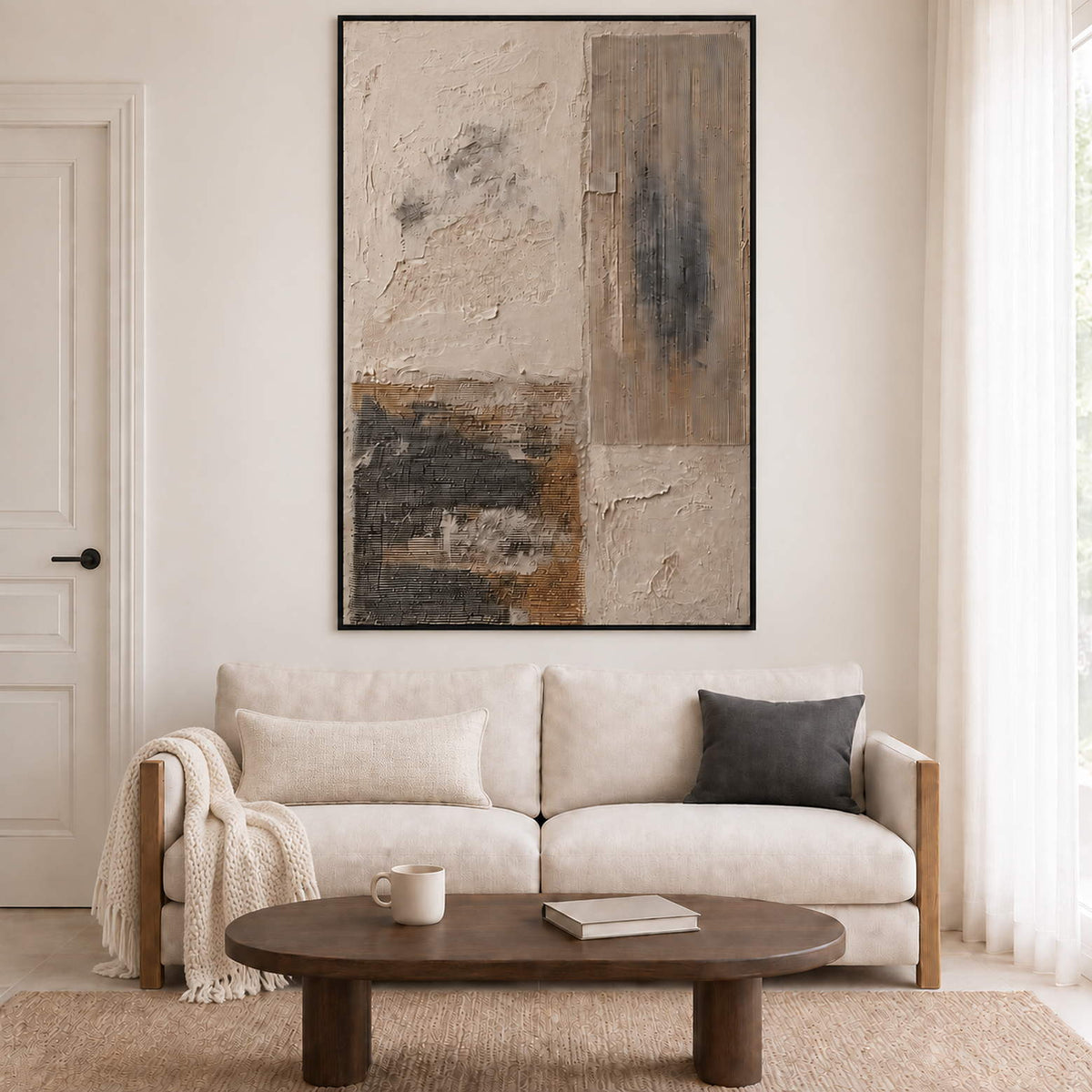 Weathered ivory and beige textures with gray blocks and dark marks in a black frame, displayed above a sofa in a living room.