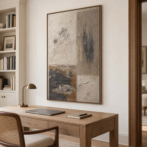 Weathered ivory and beige textures with gray blocks and dark marks in a brown wood frame, displayed in a home office.