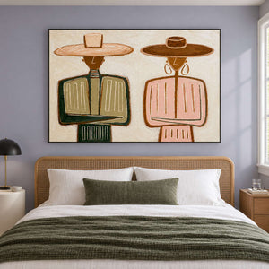 Two-hat artwork above a woven headboard and green bedding.