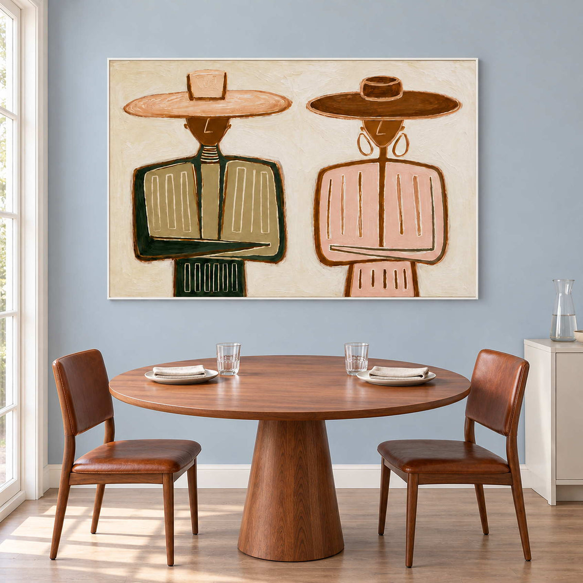 Green-and-pink portrait behind a round table and brown dining chairs.