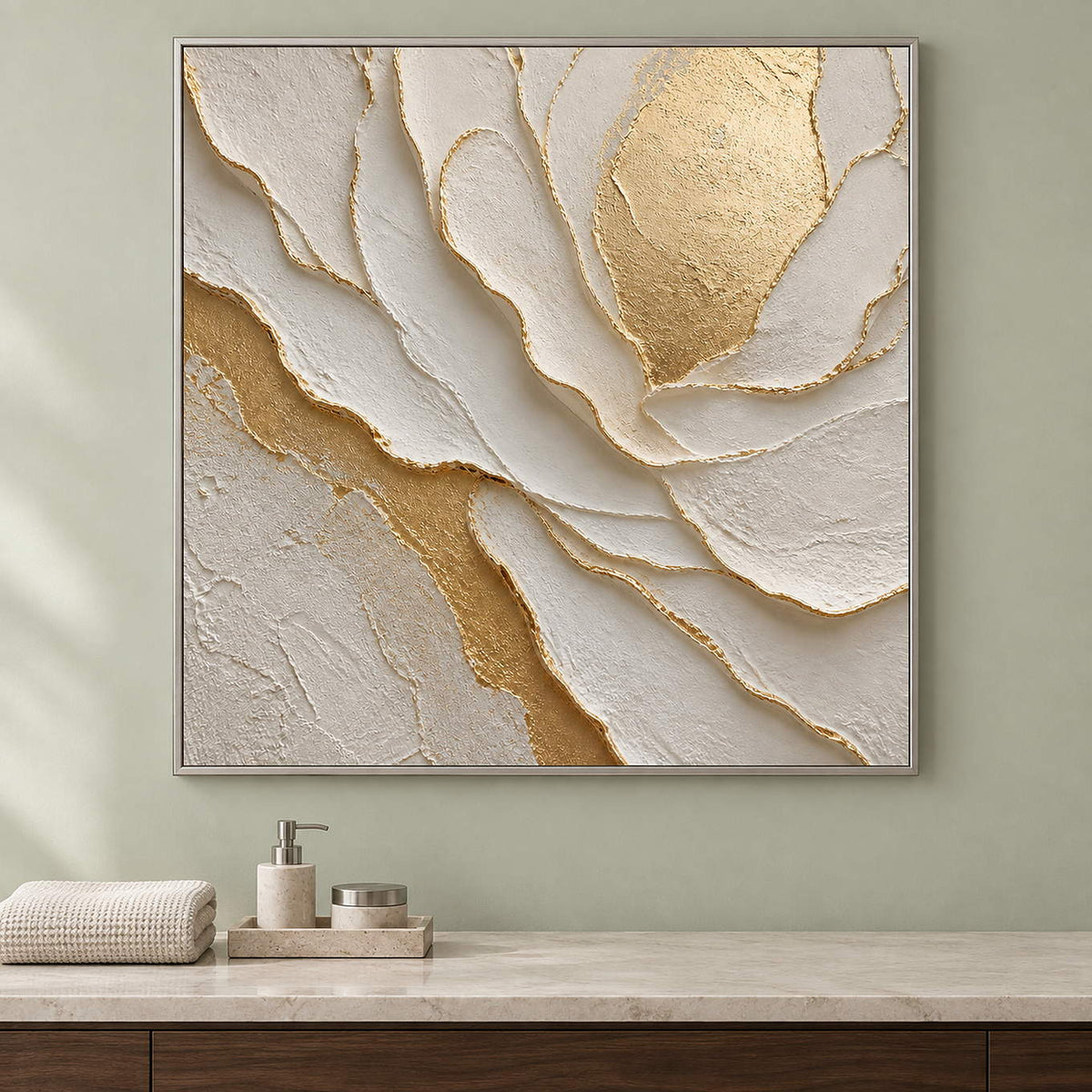 Hand-painted sculptural flower in layered ivory, white, and warm gold, displayed in a bathroom dry area in a silver frame.