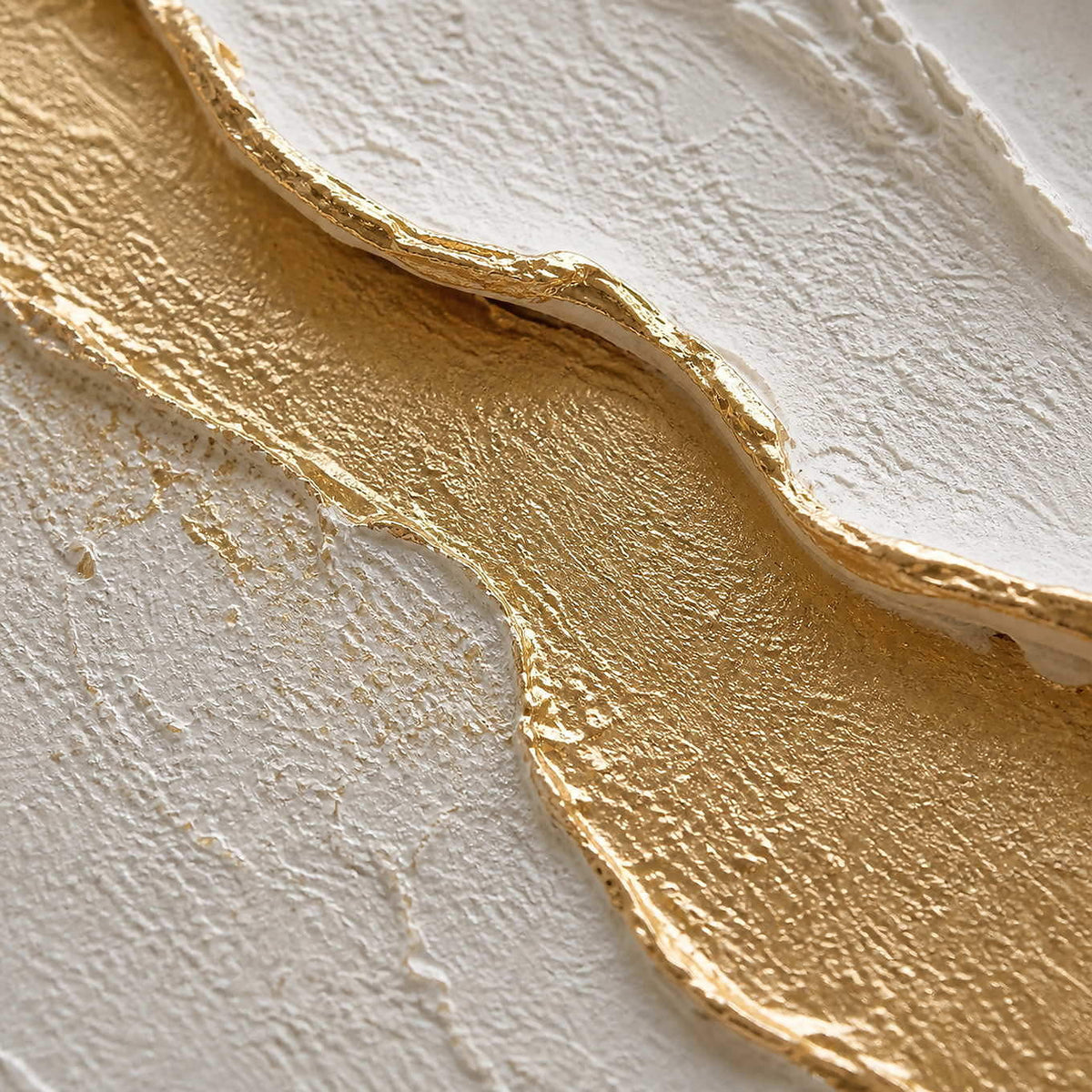 Close-up of raised ivory petals edged with luminous gold texture.