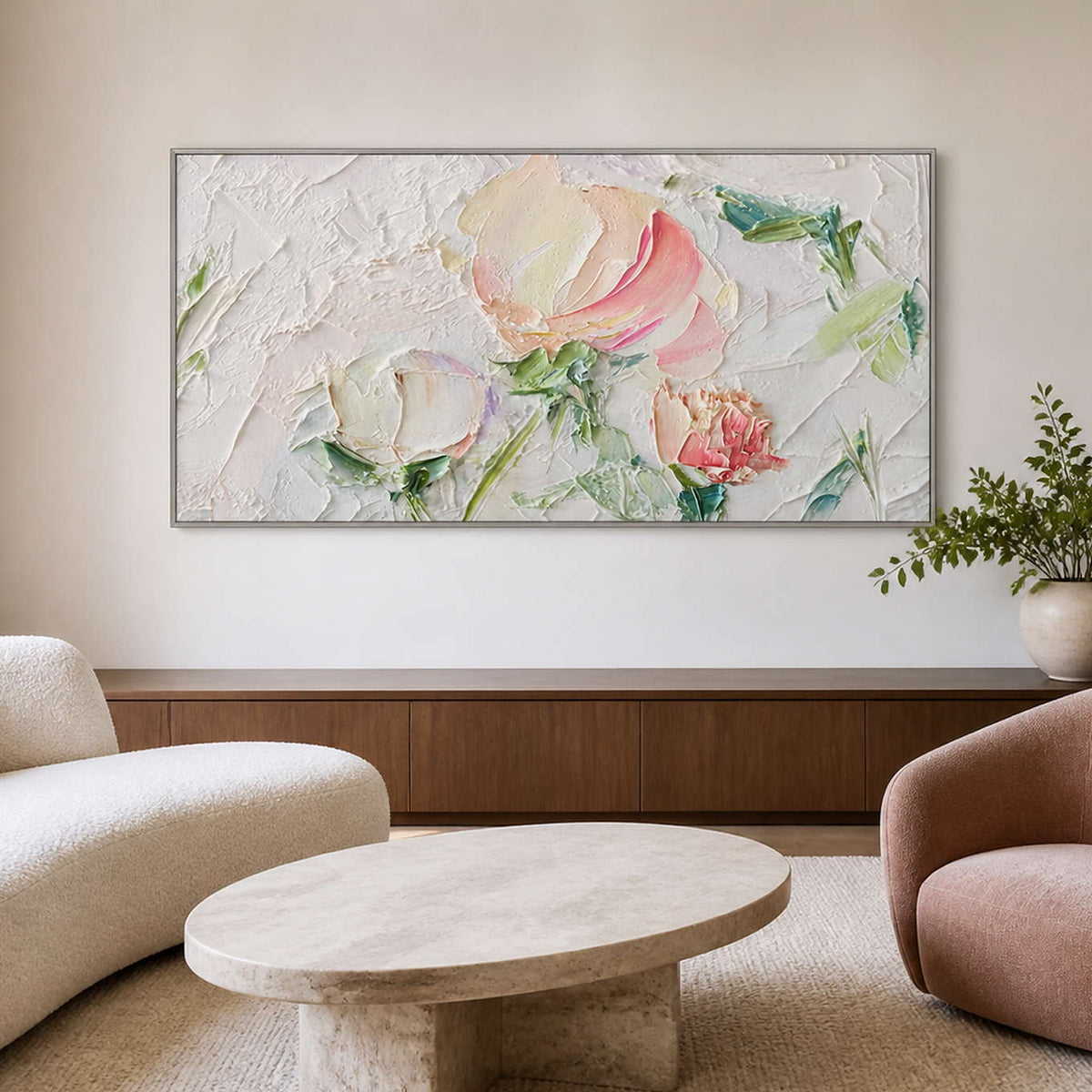 Silver framed pink floral artwork over a walnut sideboard beside rounded lounge seating.