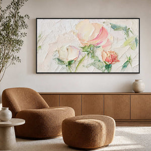 Black framed floral painting above a brown reading chair and matching ottoman.