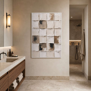 White framed cream grid artwork beside a bathroom vanity and recessed shower opening.
