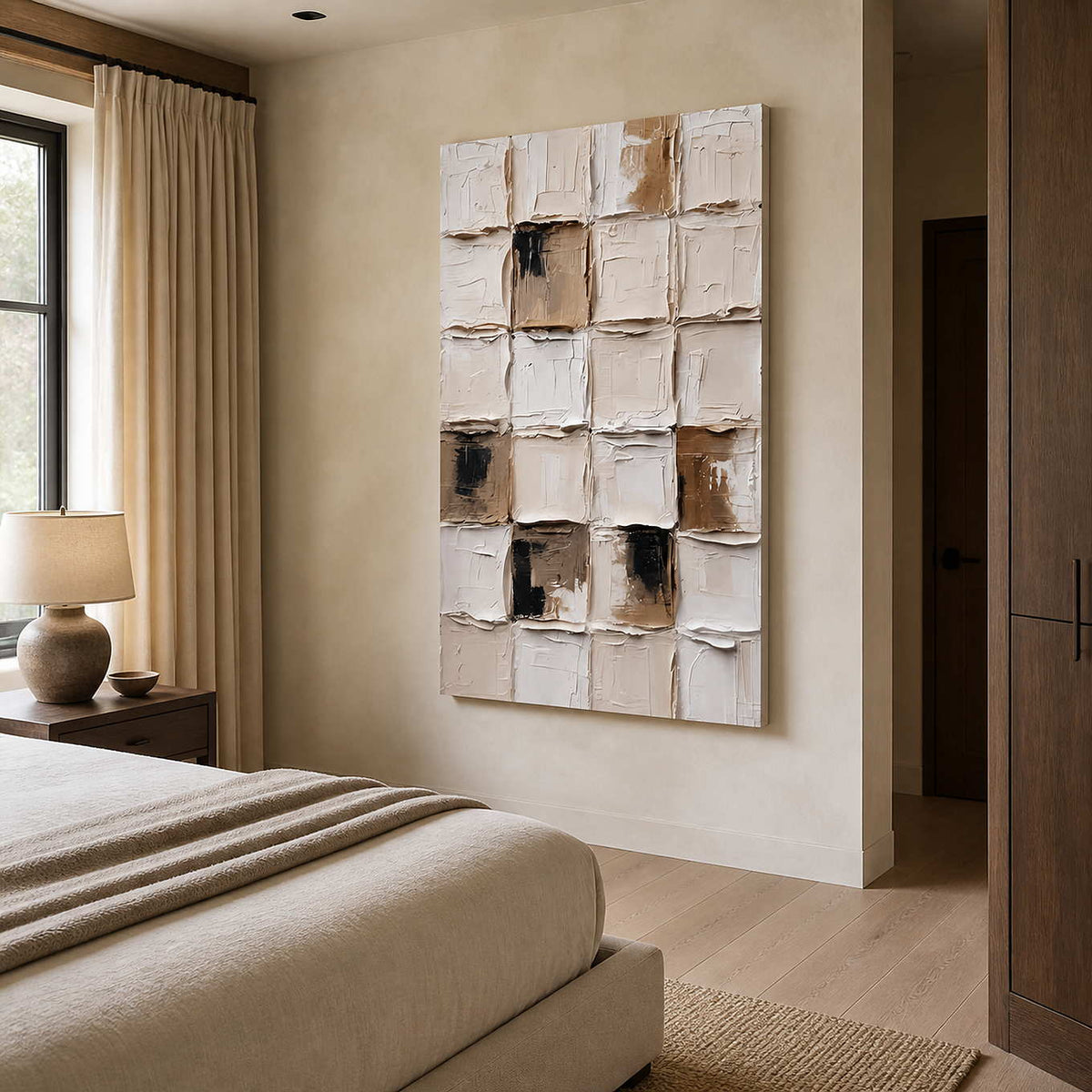 Frameless cream abstract painting on a bedroom side wall beside layered neutral bedding.