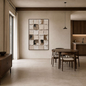 Neutral grid artwork in a walnut frame beside a dark wood dining table.