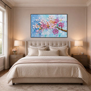 Textured floral painting displayed above a soft neutral bedroom.