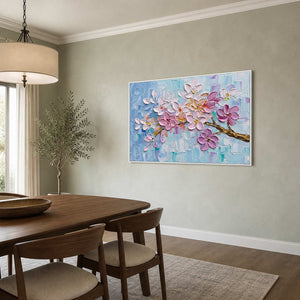 Pink botanical wall art displayed in a pale green dining room.