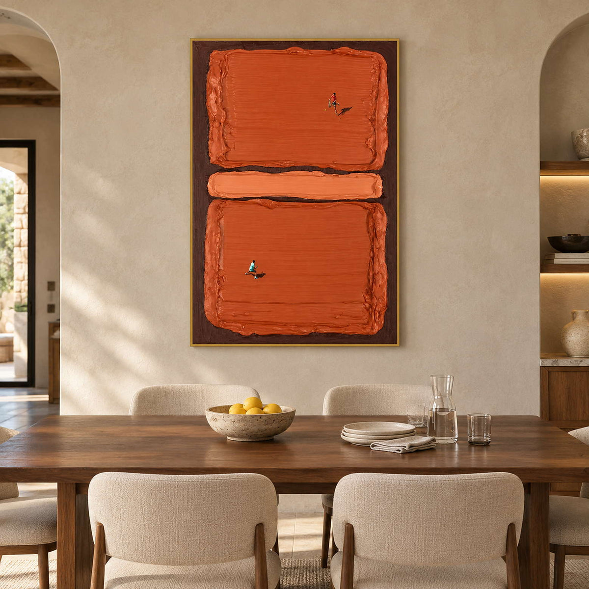 Terracotta tennis painting behind a wooden dining table with cream chairs and a bowl of lemons.