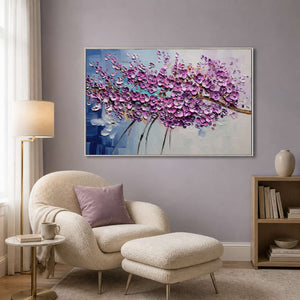 Lilac textured artwork displayed beside a soft reading chair.