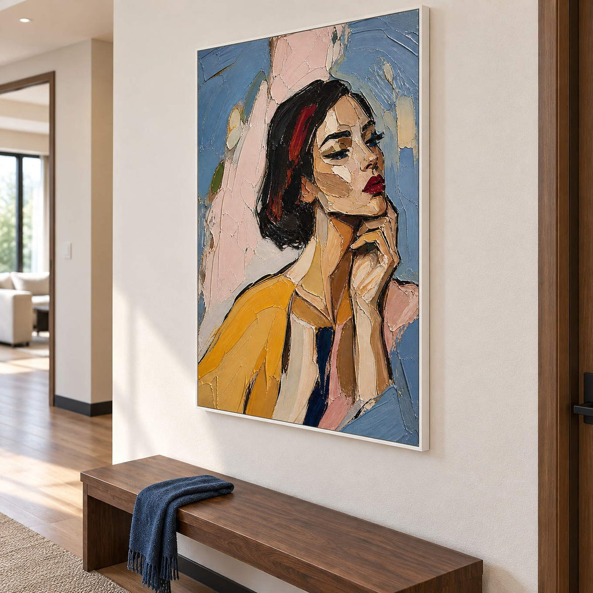 Textured portrait of a dark-haired woman in mustard yellow in a white frame in a hallway.