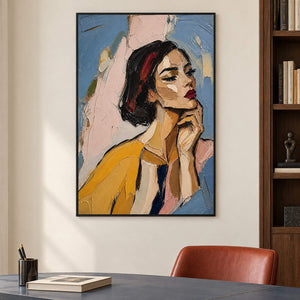Textured portrait of a dark-haired woman in mustard yellow in a black frame in a home office.