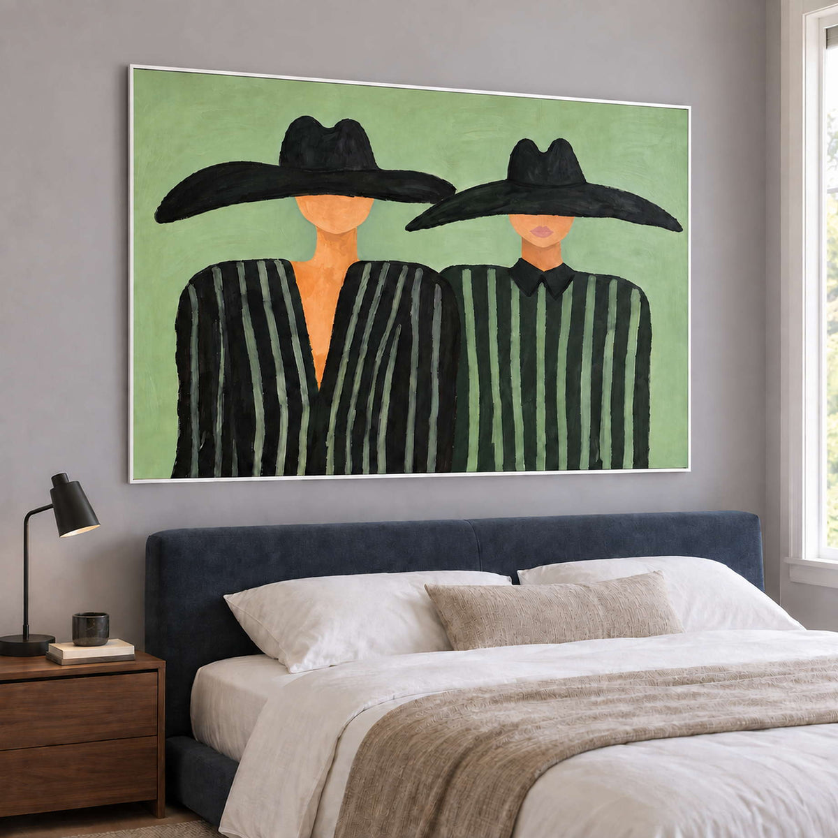 Wide companion portrait above a blue upholstered bed.