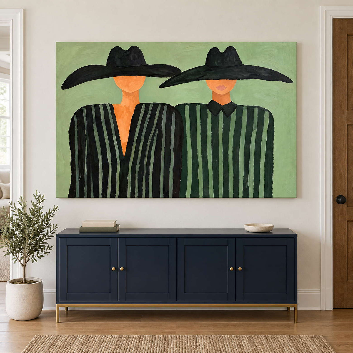 Green-striped pair over a navy sideboard and potted tree.