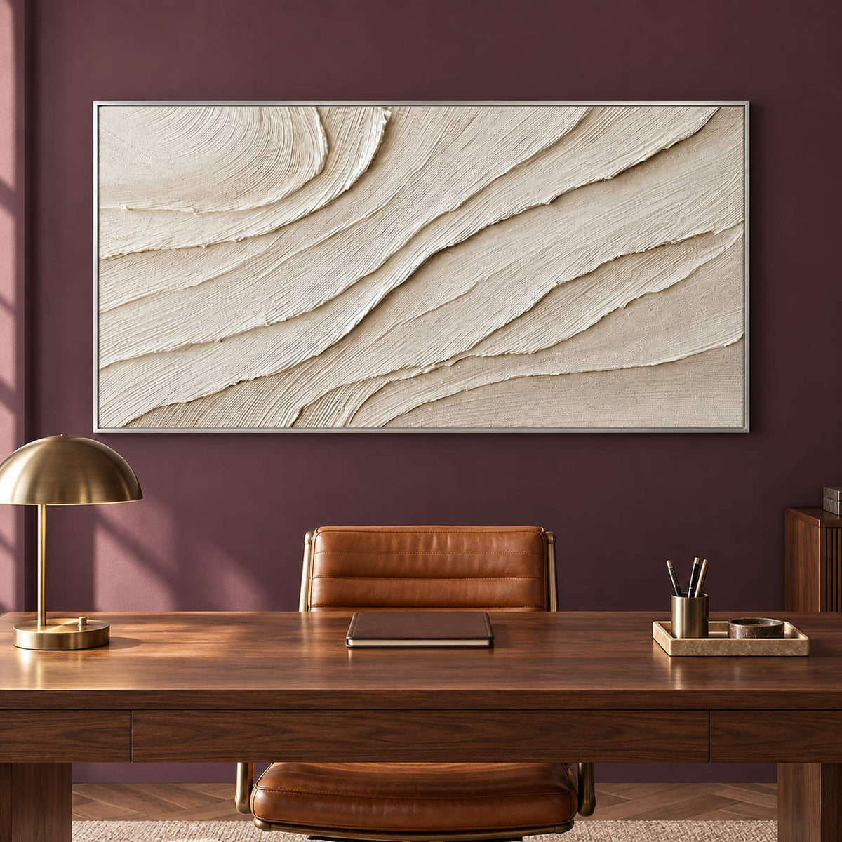 Panoramic ivory abstract wall art with layered flowing relief, displayed in a study in a silver frame.