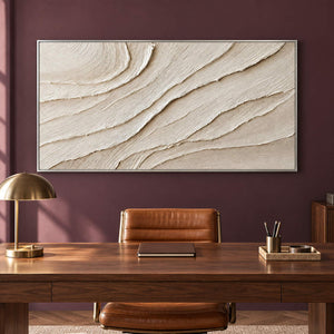 Panoramic ivory abstract wall art with layered flowing relief, displayed in a study in a silver frame.