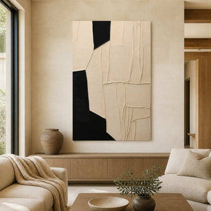 Frameless cream and black abstract artwork above wooden furniture in a neutral living room.
