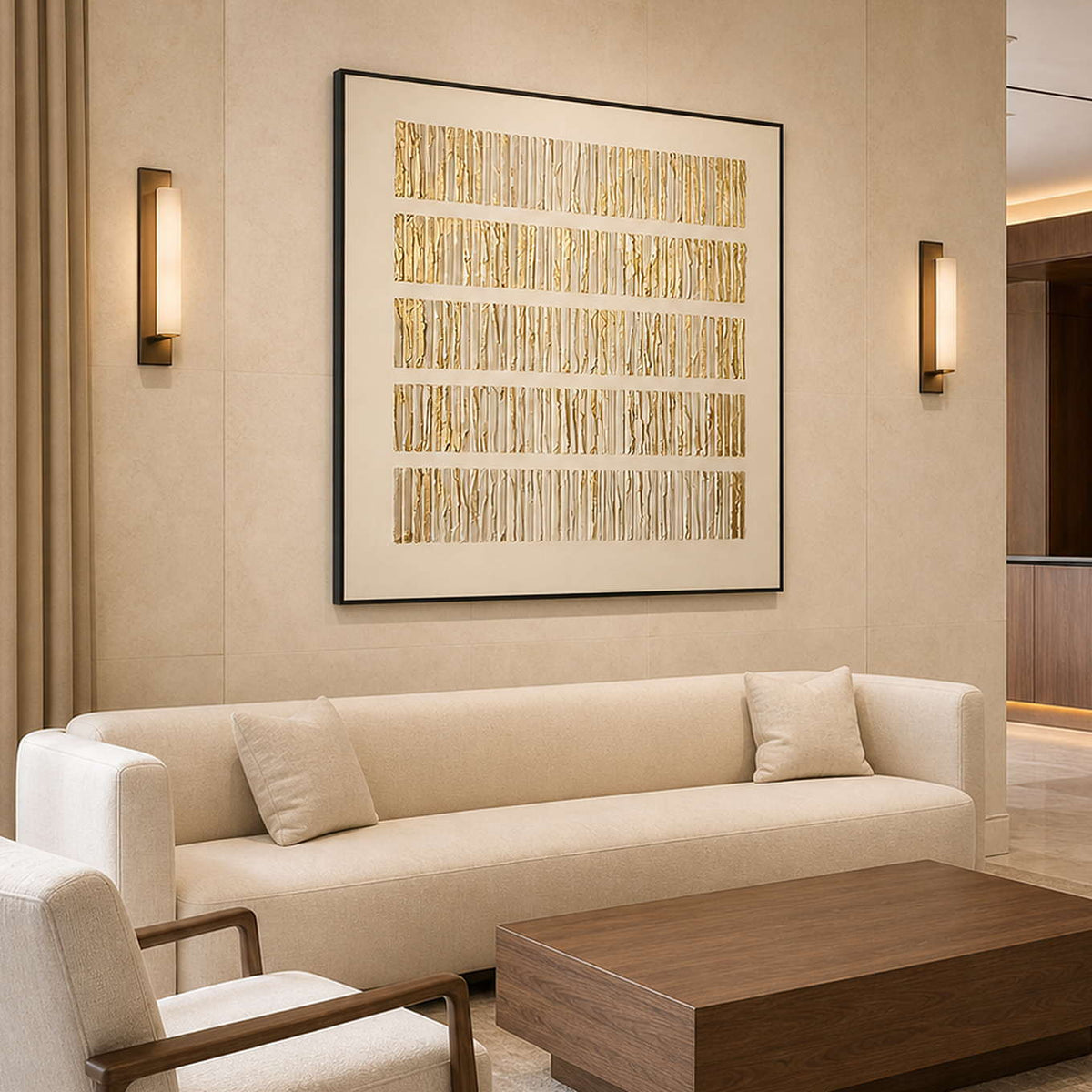 Black framed gold ridged artwork above a cream sofa in a hotel lobby.